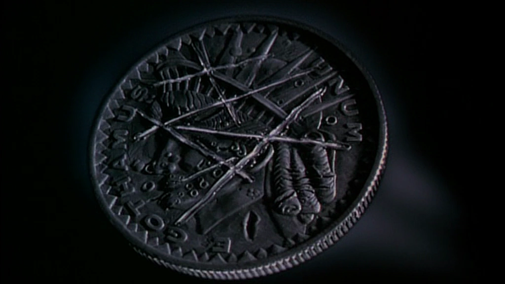  A close-up of a scarred, two-headed coin.